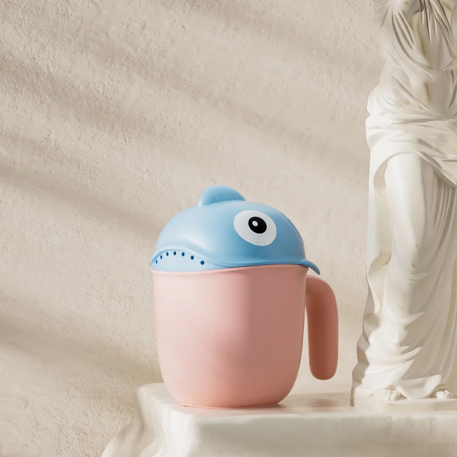 Baby Shark rinse cup by Baby Bubble, tear-free hair washing helper for children, with colorful shark design and easy-grip handle.