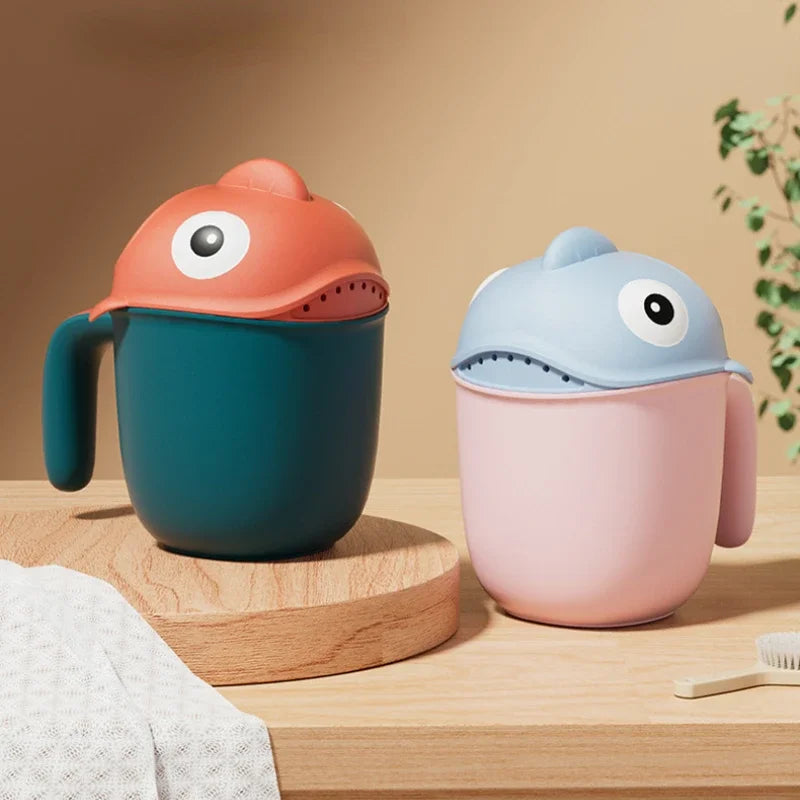 Baby Shark rinse cup by Baby Bubble, tear-free hair washing helper for babies, with colorful shark design and easy grip handle.