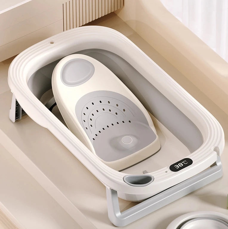 Foldable Baby Bubble bath tub with built-in temperature sensor, featuring soft padding and a compact design for easy storage.