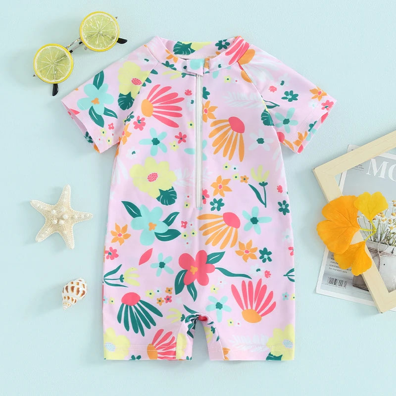 Baby girls floral zip-up rash guard romper by Baby Bubble, featuring colorful flower patterns and soft fabric for sun protection.