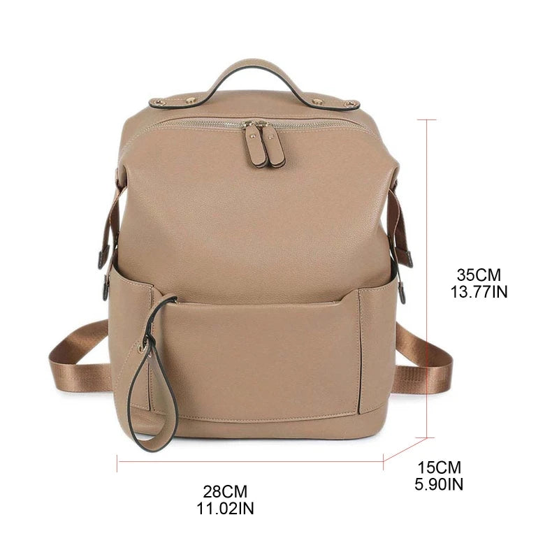 Large leather diaper bag backpack by Baby Bubble, with multiple pockets and stylish design for carrying baby essentials.