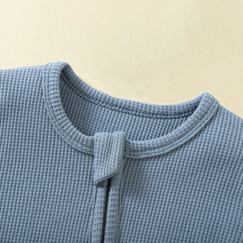Organic cotton baby romper by Baby Bubble, long-sleeve waffle jumpsuit with zipper, footed, solid color, suitable for infants boys and girls.