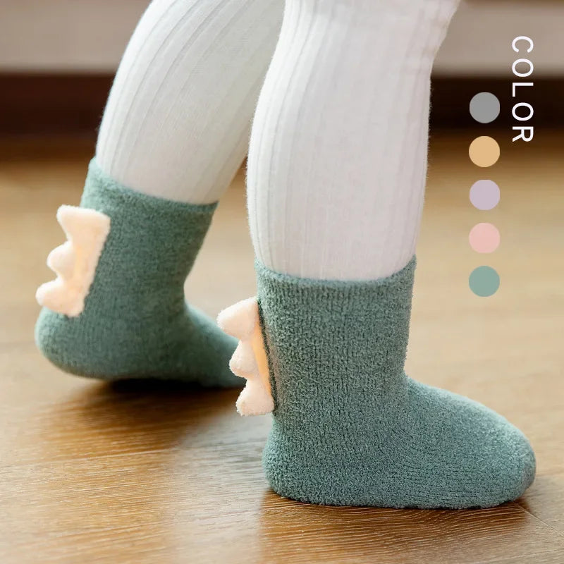 Baby Dinosaur Socks by Baby Bubble, soft and warm baby socks featuring colorful dinosaur patterns on a white background.