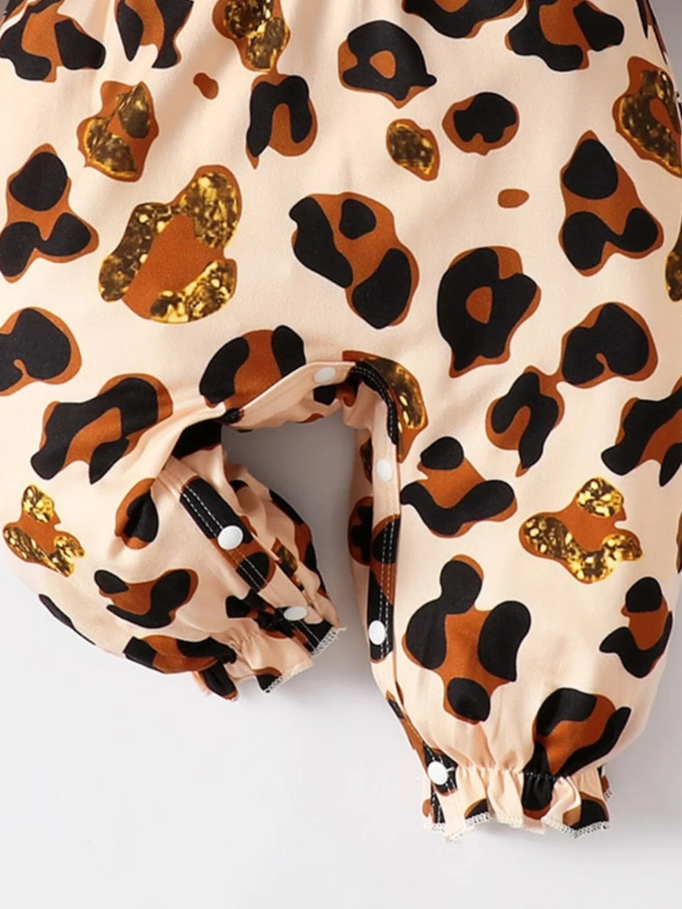 Baby Girl Leopard Jumpsuit Set by Baby Bubble featuring ruffle trim and matching headband on a soft fabric background.