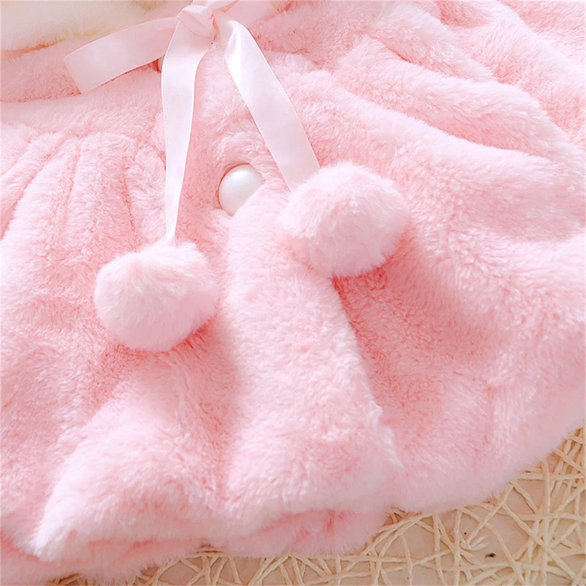 Children's wool cape and fleece jacket by Baby Bubble, featuring cozy wool fabric and ear fleece details for warmth.
