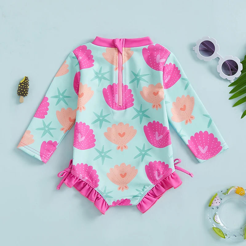 Baby Girls Rash Guard Swimsuit with shell print by Baby Bubble, featuring UV protective cover for sun-safe swimming.