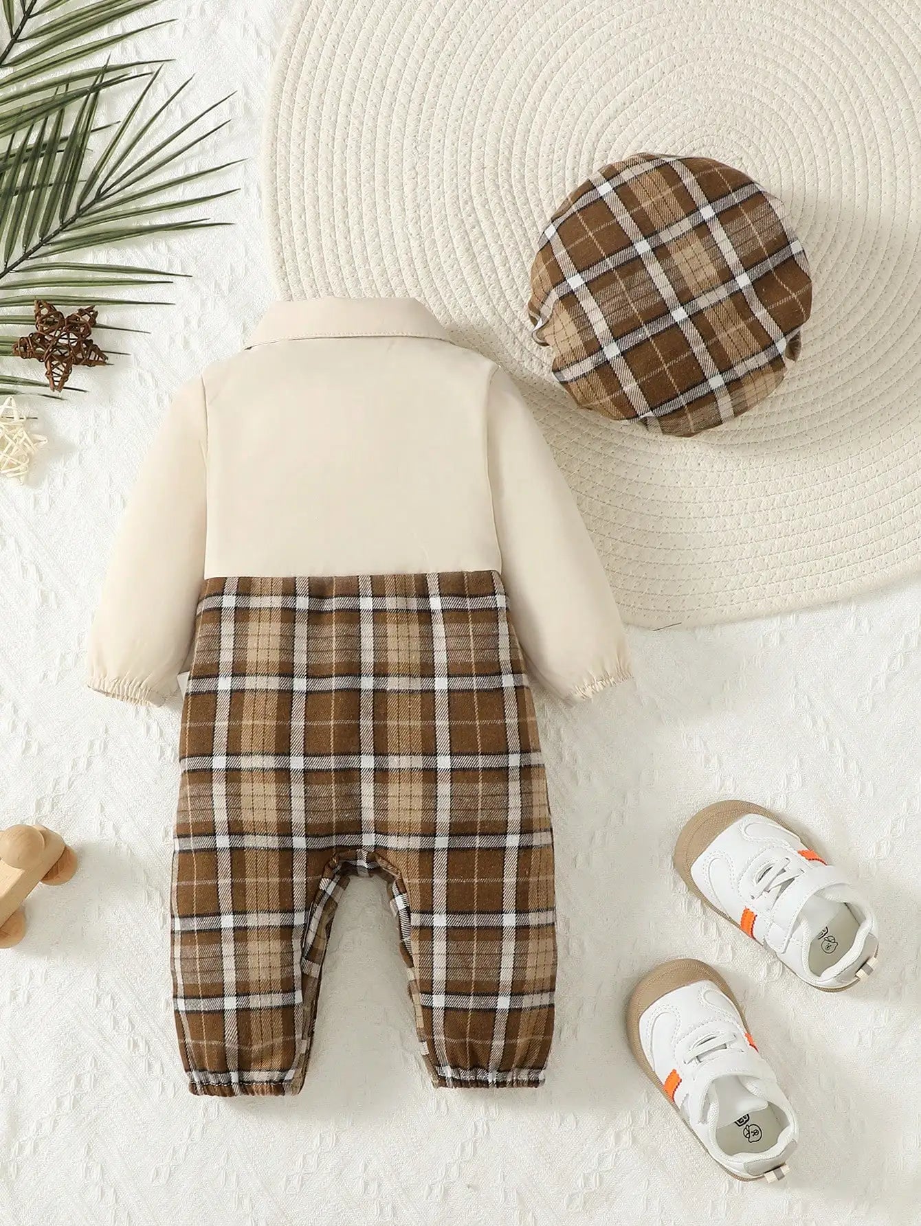 Baby boy in Baby Bubble gentleman suspenders jumpsuit and matching hat, stylish outfit for special occasions.