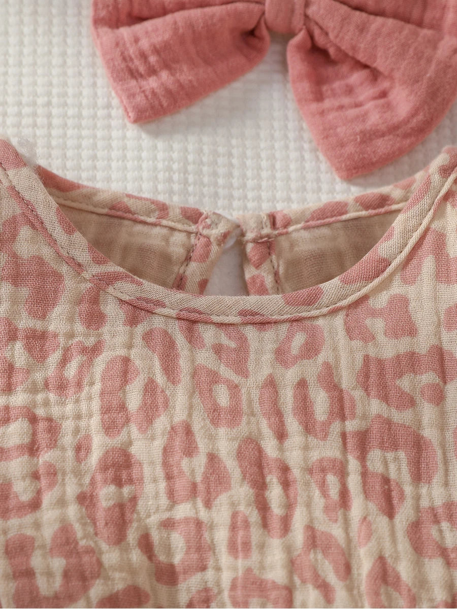Baby girl summer pink jumpsuit with bow detail, paired with matching headband, from Baby Bubble, displayed on a soft background.