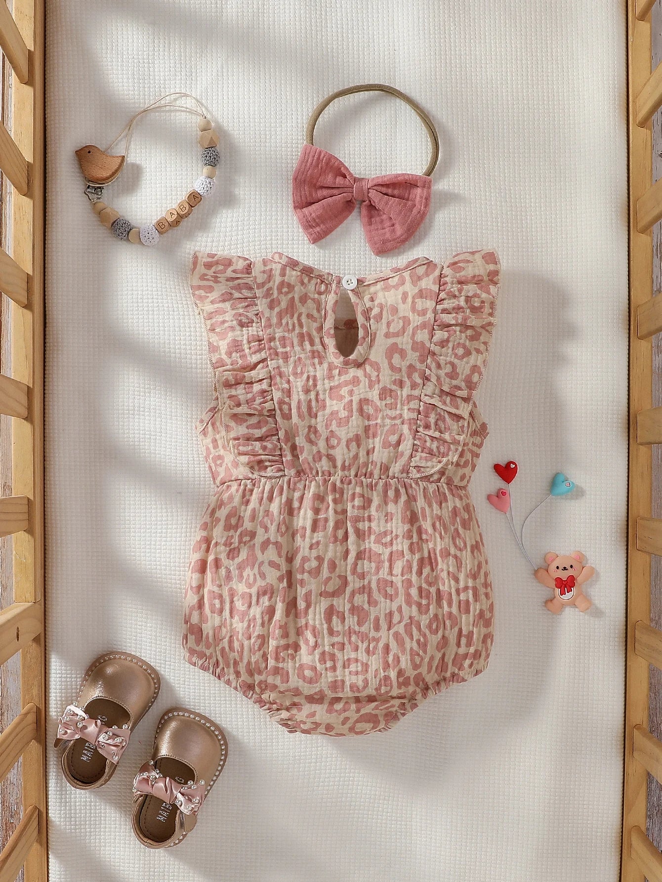 Baby Girl Summer Pink Jumpsuit with bow details and matching headband, made by Baby Bubble, suitable for warm weather.